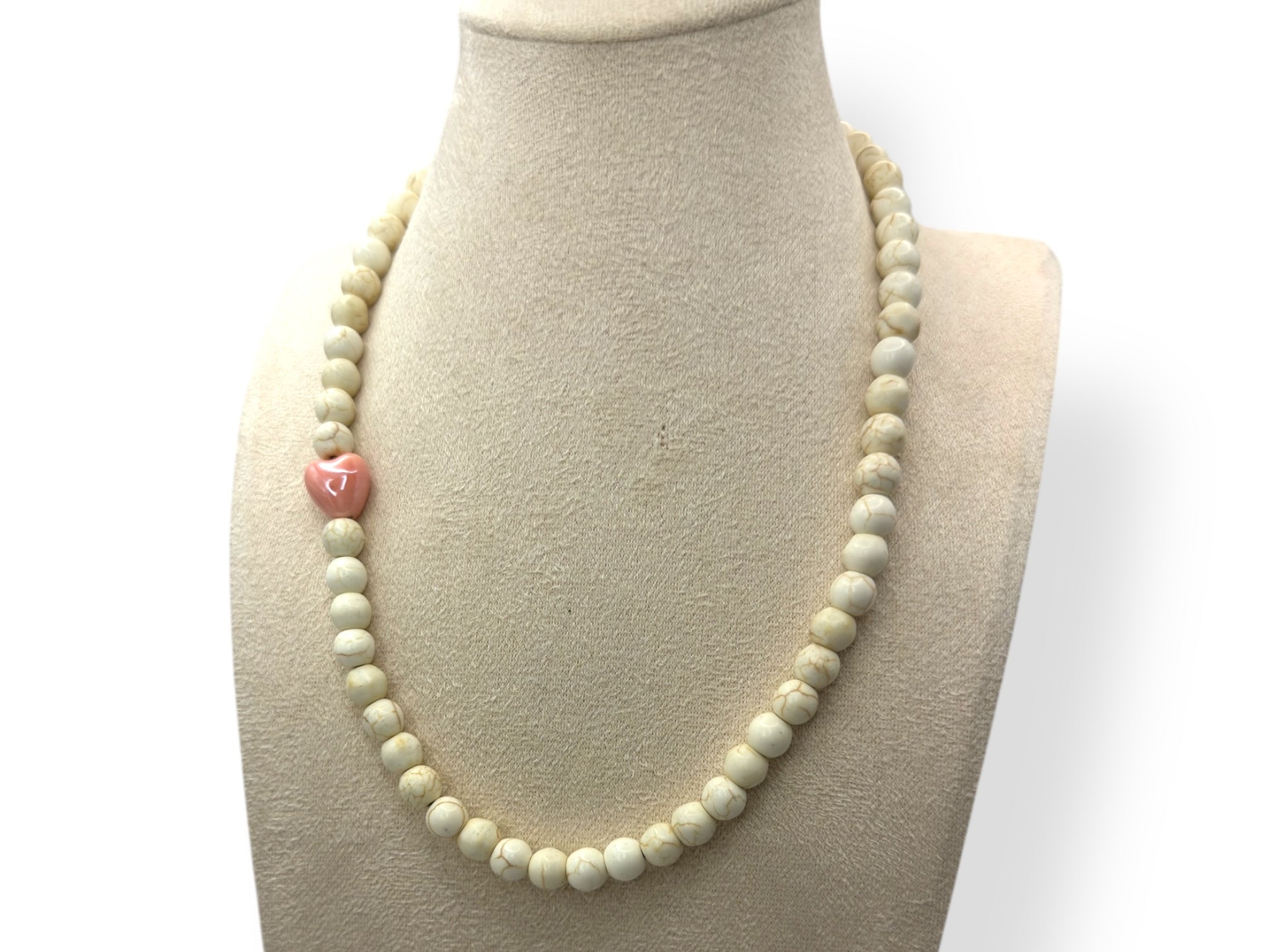 wit ketting met roze hartje close up